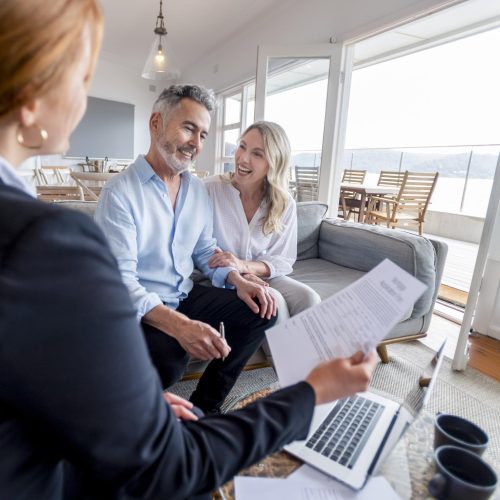 A happy, mature couple finalizes the paperwork in their new Florida Keys home.